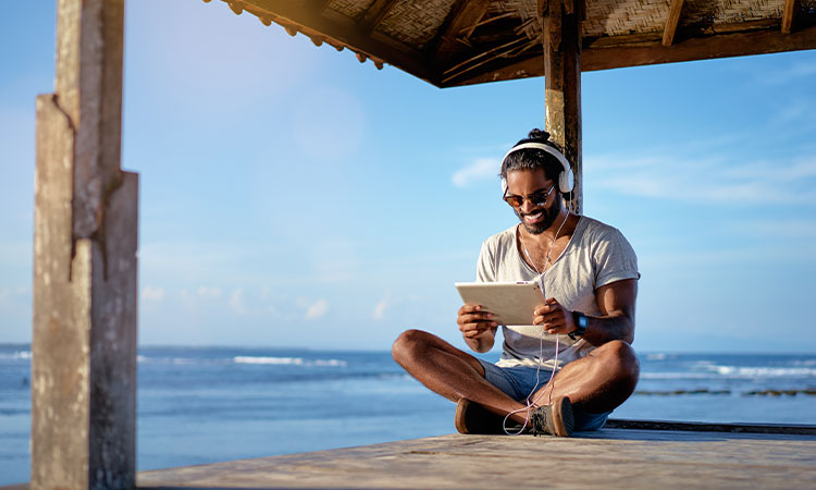 A person uses a tablet while on vacation
